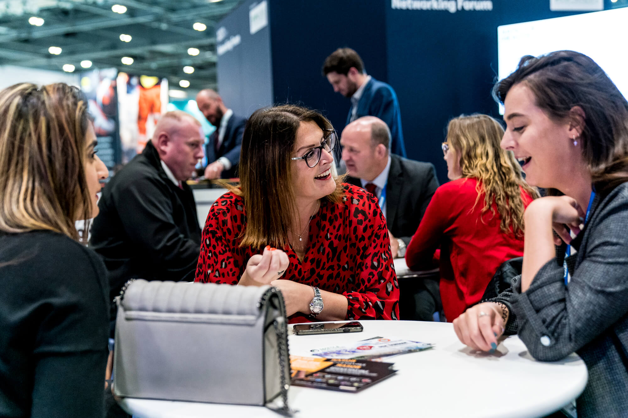 Individuals talking at a coffee table at Safety & Health Expo 2019