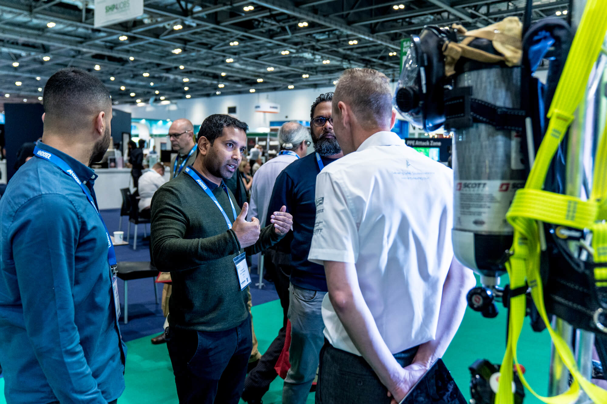 An exhibitor talking to visitors at Safety & Health Expo 2019