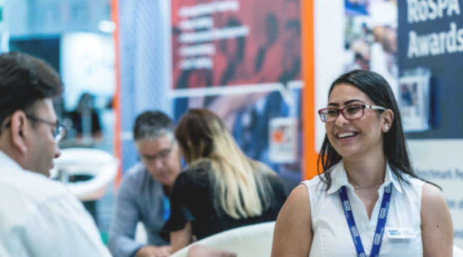 A man and woman in conversastion  on the RoSPA stand at Safety & Health Expo 2019